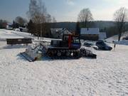 De kleine pistebully prepareert de hele helling